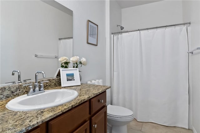 full bath with tile patterned flooring, vanity, and toilet