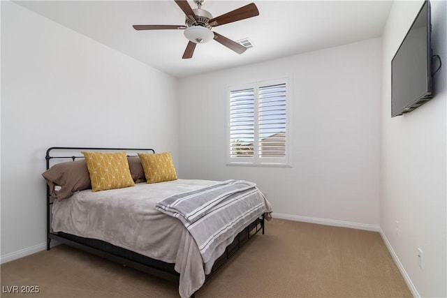 carpeted bedroom featuring a ceiling fan, visible vents, and baseboards