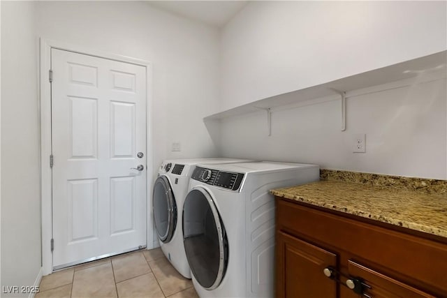 washroom with light tile patterned floors, laundry area, and independent washer and dryer