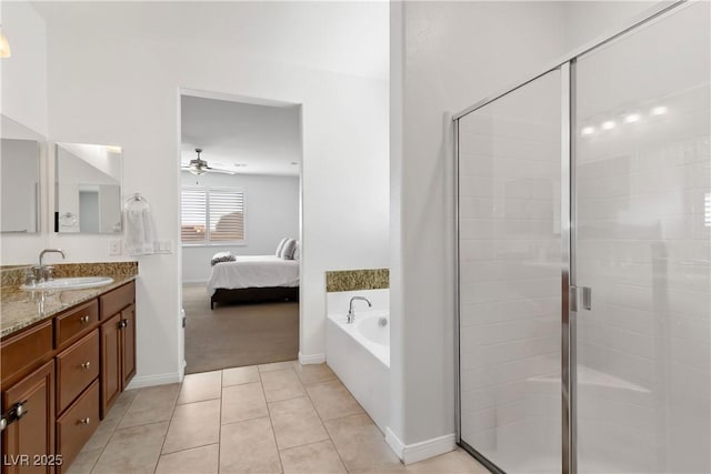 ensuite bathroom with ceiling fan, vanity, a shower stall, tile patterned floors, and ensuite bath