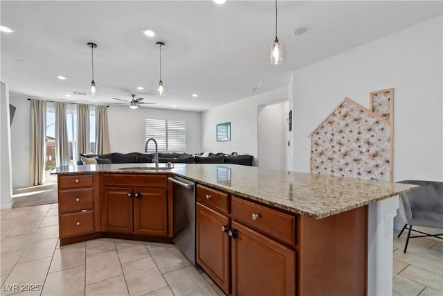 kitchen featuring brown cabinetry, open floor plan, a sink, and stainless steel dishwasher