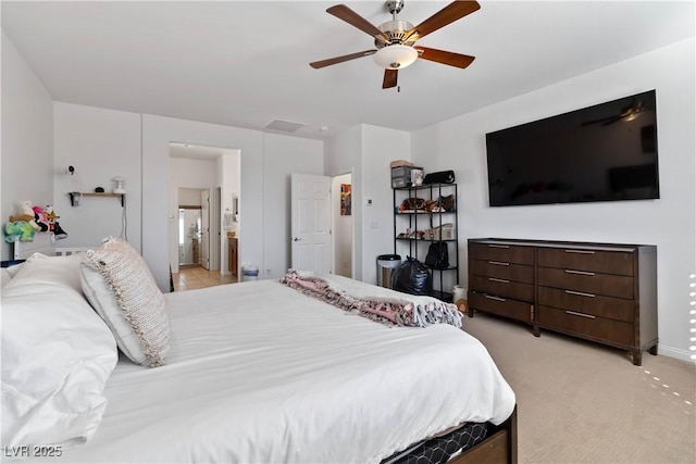 bedroom with light carpet, ceiling fan, connected bathroom, and visible vents