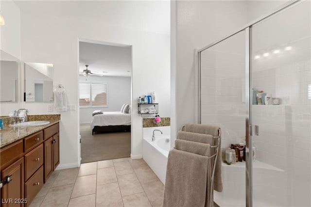 full bath with double vanity, connected bathroom, a bath, tile patterned flooring, and a sink