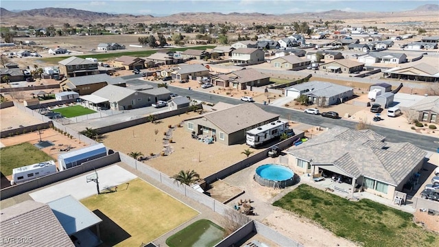 drone / aerial view featuring a residential view and a mountain view