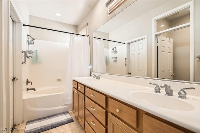 full bathroom with tile patterned flooring, double vanity, a sink, and shower / bath combo with shower curtain