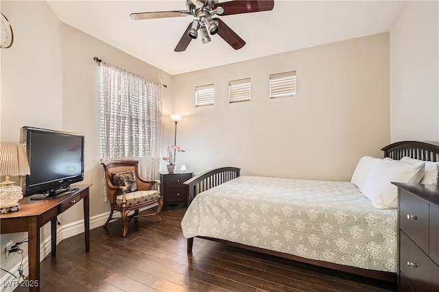 bedroom with ceiling fan, baseboards, and wood finished floors