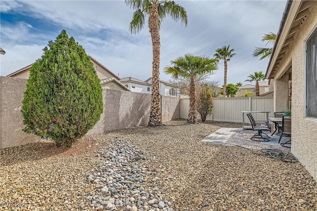 view of yard featuring a patio area and a fenced backyard