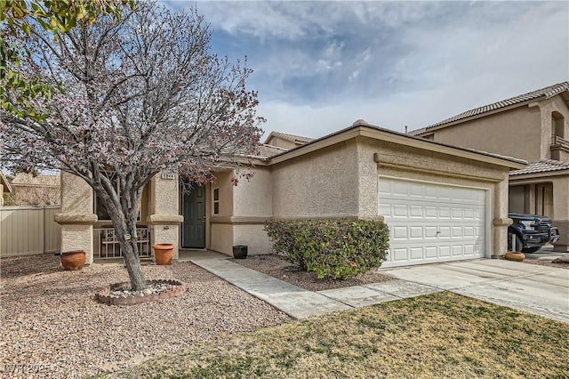 view of front facade featuring a tile roof, stucco siding, concrete driveway, fence, and a garage