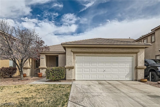 view of front of property featuring concrete driveway, a tile roof, an attached garage, and stucco siding