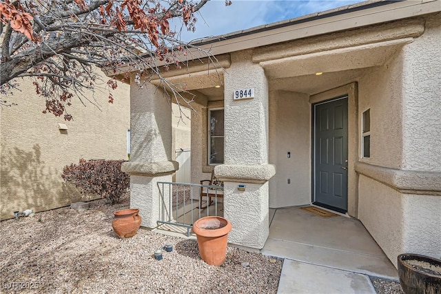 doorway to property with stucco siding