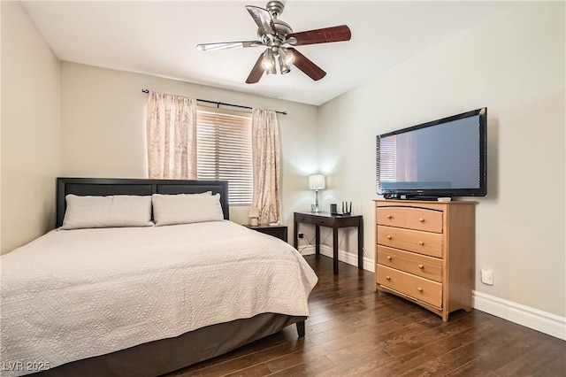 bedroom featuring ceiling fan, wood finished floors, and baseboards