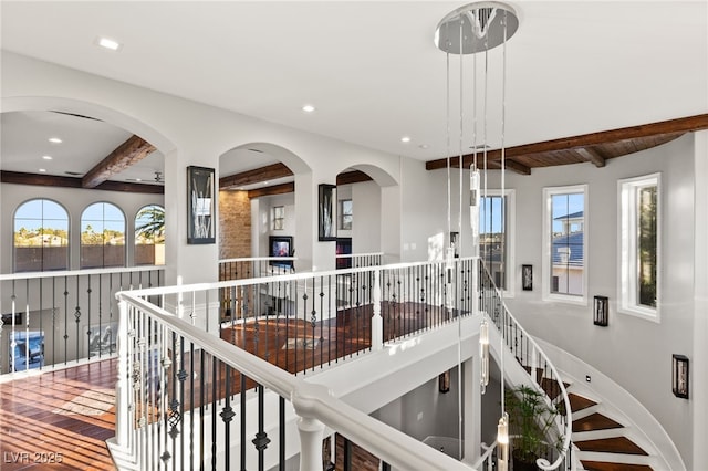 hall featuring recessed lighting, beamed ceiling, and baseboards