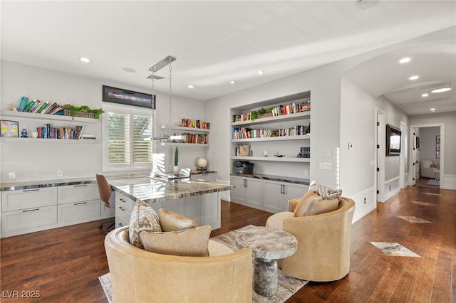 interior space with dark wood-style floors, baseboards, built in features, and recessed lighting