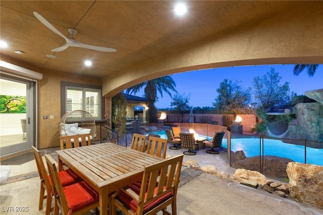 view of patio with outdoor dining space, a fenced backyard, and a fenced in pool