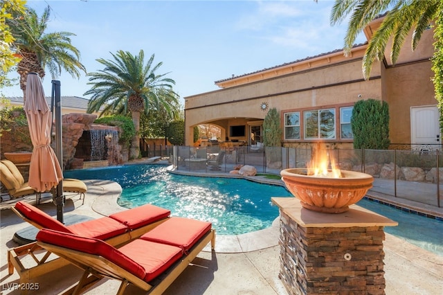 view of swimming pool featuring a patio area, fence, and a fenced in pool