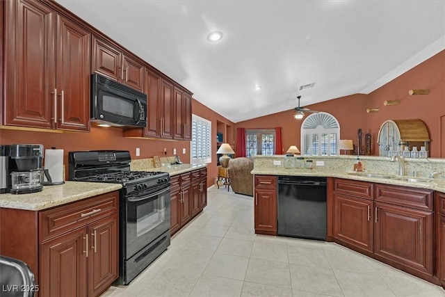 kitchen featuring light tile patterned floors, light stone countertops, vaulted ceiling, black appliances, and a sink