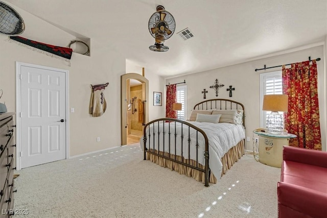 bedroom featuring carpet floors, baseboards, visible vents, and connected bathroom