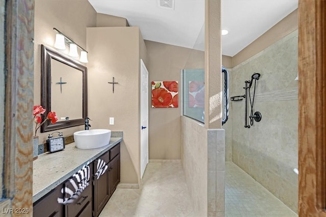 bathroom with visible vents, walk in shower, and vanity