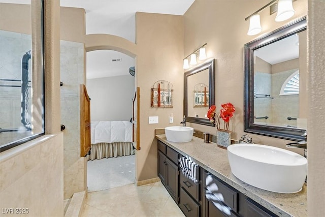 bathroom featuring connected bathroom, visible vents, a sink, and double vanity