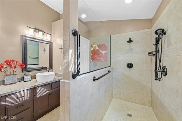 full bathroom featuring walk in shower and vanity