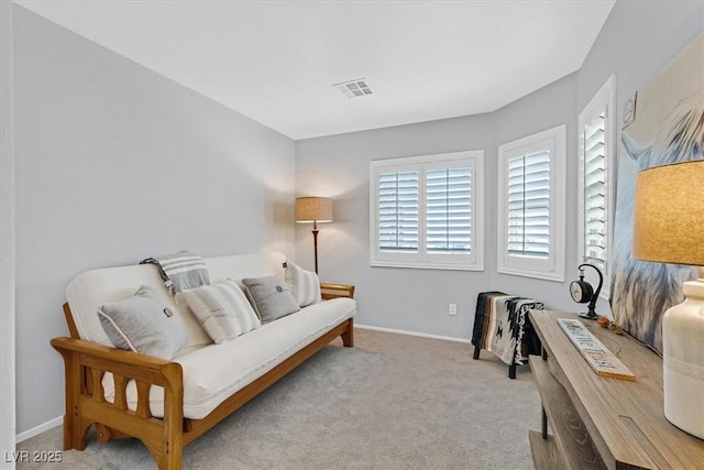 carpeted living room featuring visible vents and baseboards