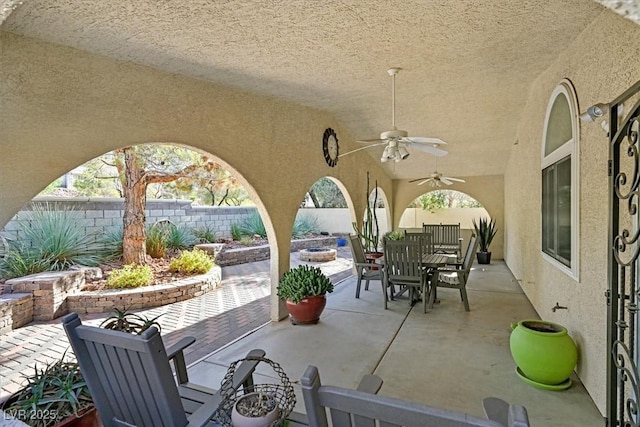 view of patio featuring a fenced backyard, a ceiling fan, and outdoor dining space