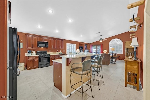 kitchen with lofted ceiling, a breakfast bar area, open floor plan, black appliances, and recessed lighting