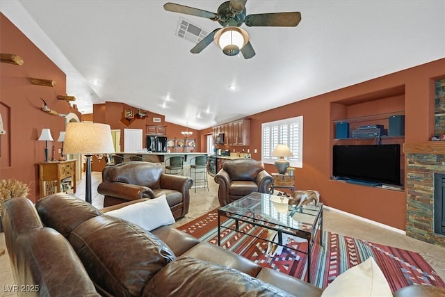 living area featuring lofted ceiling, visible vents, a stone fireplace, and light tile patterned flooring