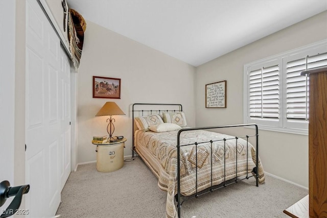 bedroom with carpet floors, a closet, and baseboards