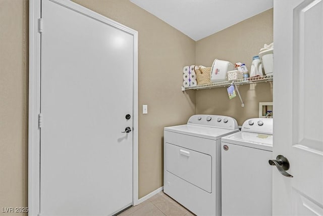 clothes washing area with laundry area, baseboards, light tile patterned flooring, and independent washer and dryer