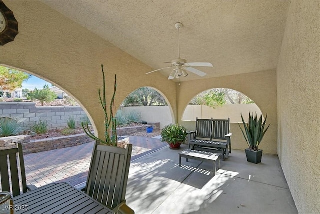 view of patio with a fenced backyard and ceiling fan