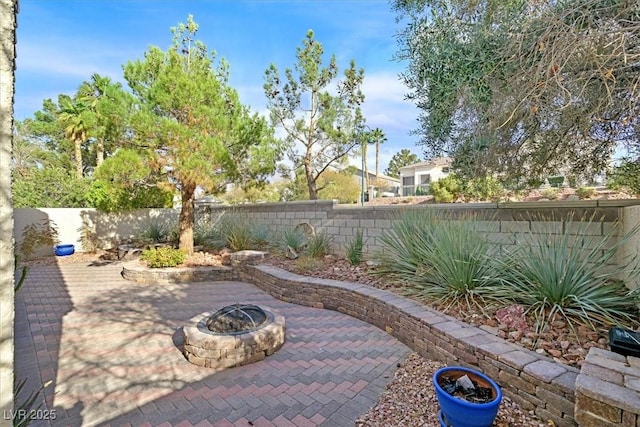 view of patio with a fire pit and a fenced backyard