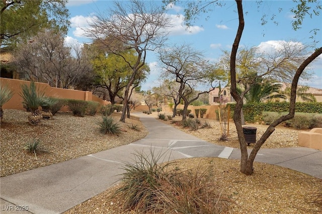 view of community with a fenced front yard