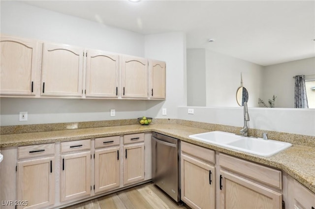 kitchen with light brown cabinetry, dishwasher, light countertops, light wood-style flooring, and a sink