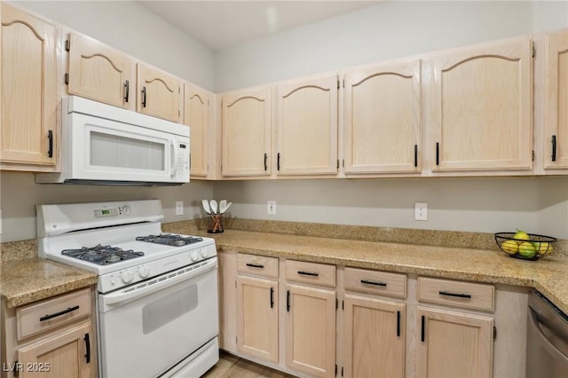 kitchen featuring white appliances and light brown cabinets