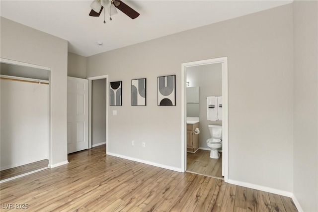 bedroom featuring light wood-type flooring, baseboards, a closet, and ensuite bathroom