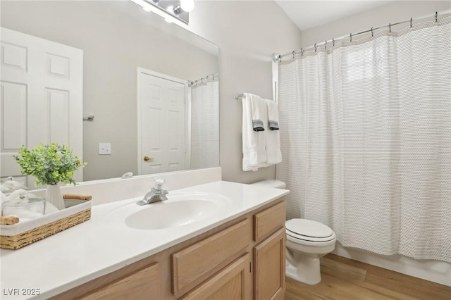 bathroom with toilet, shower / bath combo, wood finished floors, and vanity