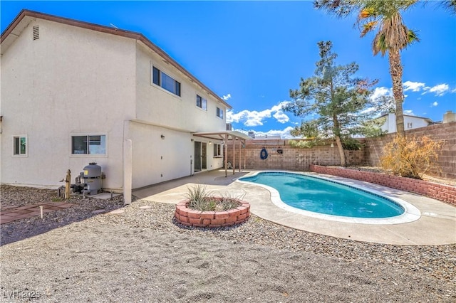 view of swimming pool featuring a fenced in pool, a patio, and a fenced backyard