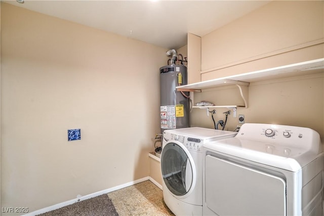 clothes washing area featuring water heater, laundry area, washing machine and dryer, and baseboards