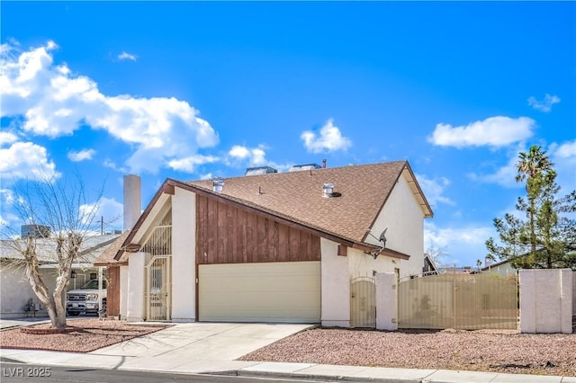 view of property exterior with a garage, roof with shingles, driveway, and a gate