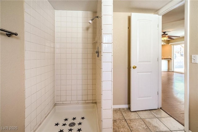 bathroom with a shower stall, a ceiling fan, and tile patterned floors