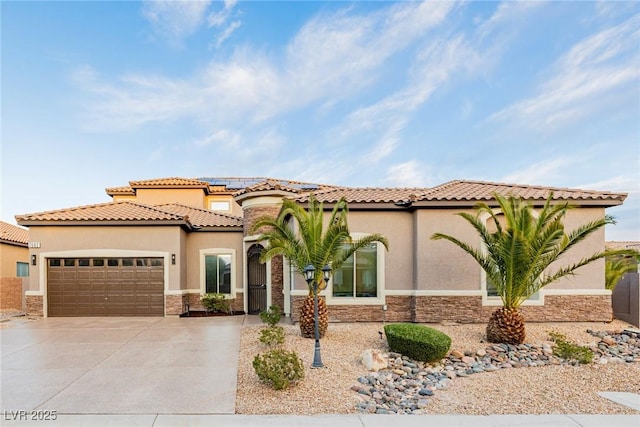 mediterranean / spanish-style house featuring stone siding, driveway, an attached garage, and stucco siding