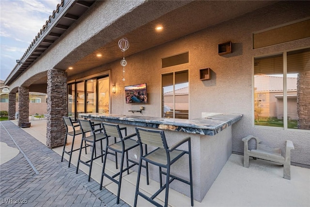 view of patio / terrace featuring outdoor dry bar