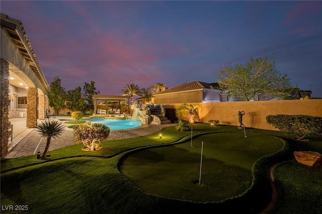 view of swimming pool with a patio, an outdoor kitchen, and a fenced in pool