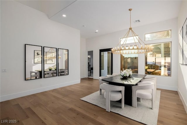 dining area featuring recessed lighting, visible vents, baseboards, light wood-style floors, and an inviting chandelier