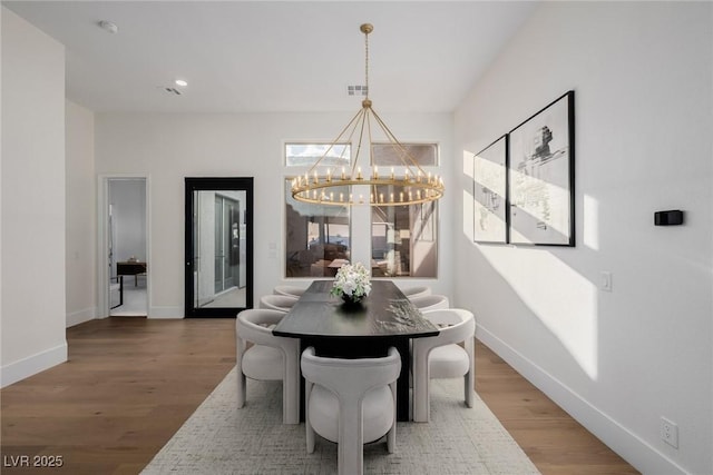 dining area with recessed lighting, visible vents, wood finished floors, a chandelier, and baseboards