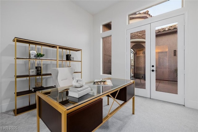 office area with carpet, french doors, and arched walkways