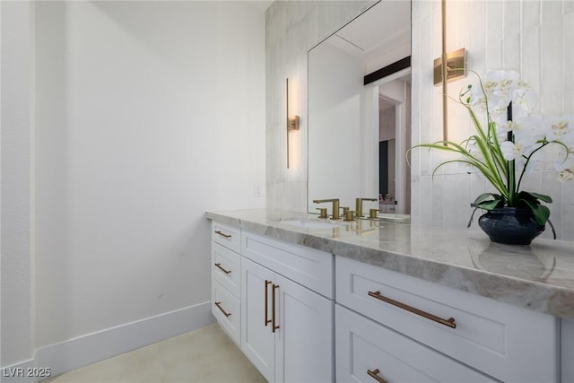 bathroom with baseboards and vanity