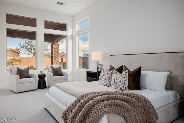 carpeted bedroom featuring visible vents