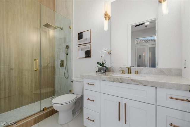 full bath with toilet, a shower stall, and vanity